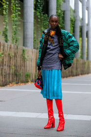 model, red polish boots, high boots, high heels boots, light blue skirt, mid long skirt, pleated skirt, prada bag, hand bag, fire printed bag, black bag, bucket bag, red bag, printed bag, floral printed blouse, dark grey blouse, silk blouse, high collar blouse, dark grey t-shirt, floral printed t-shirt, green coat, green bombers, fur collar coat, checked coat, fur coat, make up, make up details, studs make up, strassed make up, fashion week, frenchystyle, FW, jonathan paciullo, street style, SPRING SUMMER 2020, SS 20, PFW, PARIS, vertical, full length