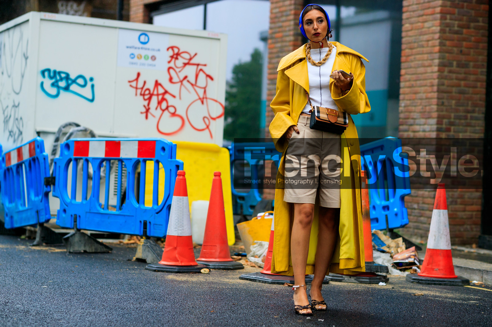 animal print sandals, beige bermuda shorts, big buckle bag, big chain necklace, brown leather bag, burberry bag, beige leather bag, checked bag, crossbody bag, flowers earrings, golden necklace, high heels sandals, high heels slippers, oversize trench coat, plastic earrings, white top, yellow trench coat, fashion week, frenchystyle, FW, jonathan paciullo, street style, atmosphere details, horizontal, full length