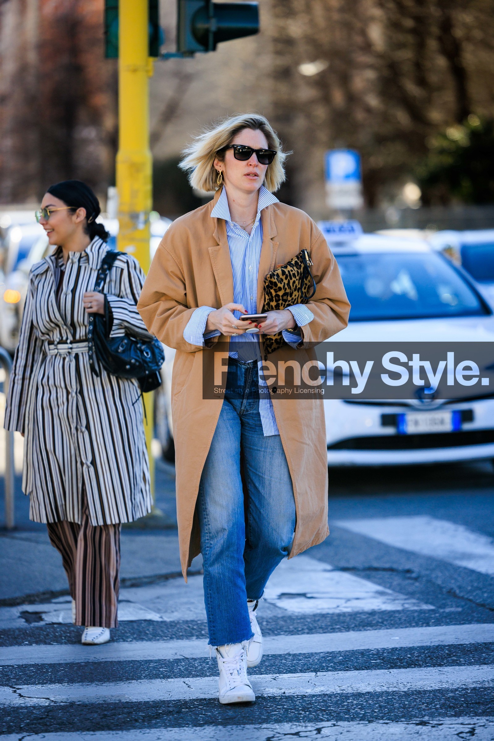 black sunglasses, beige trench, blue shirt, white sneakers, classic jeans, denim pants, blue stripe shirt, printed pouch, animal print pouch, yellow pouch, golden earrings, fashion week, frenchystyle, FW, jonathan paciullo, street style, vertical, full length