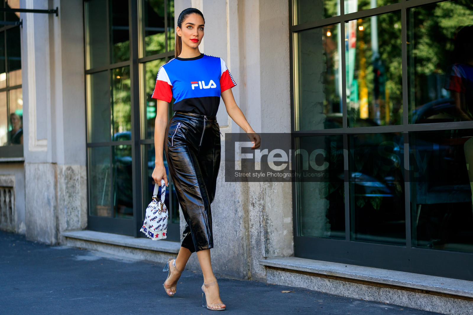 black pants, blue t shirt, crop top, fendi, fila, fringes, graphic bag, graphic top, high heels, jessica kahawaty, leather bag, leather pants, leather shoes, monogram, printed bag, printed t shirt, red lips, transparent shoes, trousers, white bag, street style, jonathan paciullo, FW, frenchystyle, fashion week, MFW, MILAN, SPRING SUMMER 2019, SS 19, atmosphere details, horizontal, full length