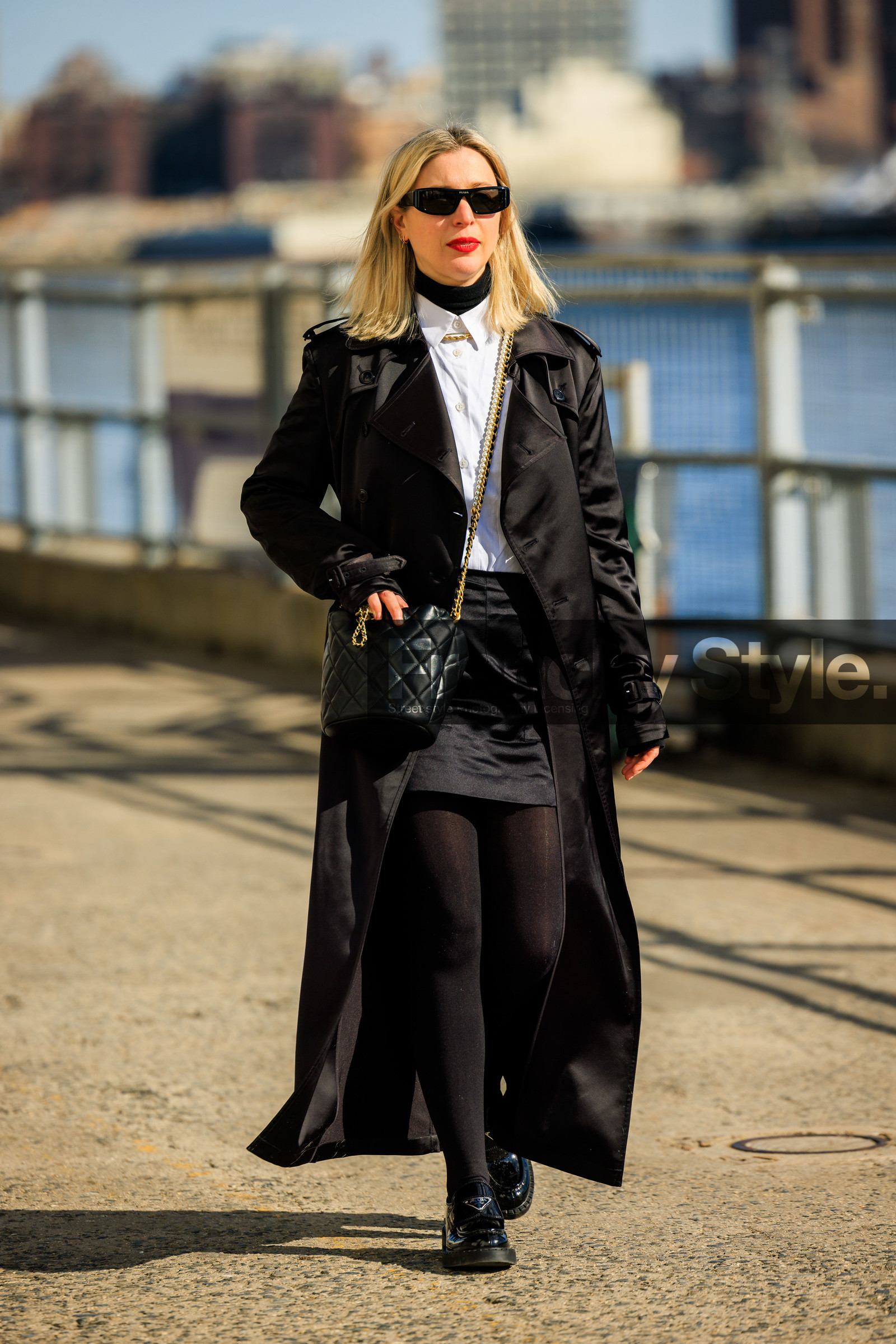 chanel crossbody, chanel bag, bucket bag, chanel bucket bag, black sunglasses, black full look, white shirt, black long trench, satin trench coat, mini skirt, black skirt, black handbag, black stockings, prada derbies, prada shoes, black derbies, leather derbies, fashion week, frenchystyle, FW, jonathan paciullo, street style, NYFW, NEW YORK, AUTUMN WINTER 2022-2023, FALL WINTER 2022_2023, FW 22-23, vertical, full length