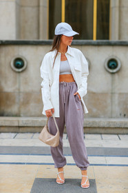alice & j.s, alice barbier, white cap, white leather jacket, white leather shirt, white leather bag, lacoste cap, sportswear, jogging pants, purple pants, prada bag, light beige bag, white top, cropped top, kitten heels sandals, multi straps sandals, multi necklace, golden necklace, fashion week, frenchystyle, FW, jonathan paciullo, street style, SPRING SUMMER 2020, SS 20, PFW, PARIS, vertical, full length