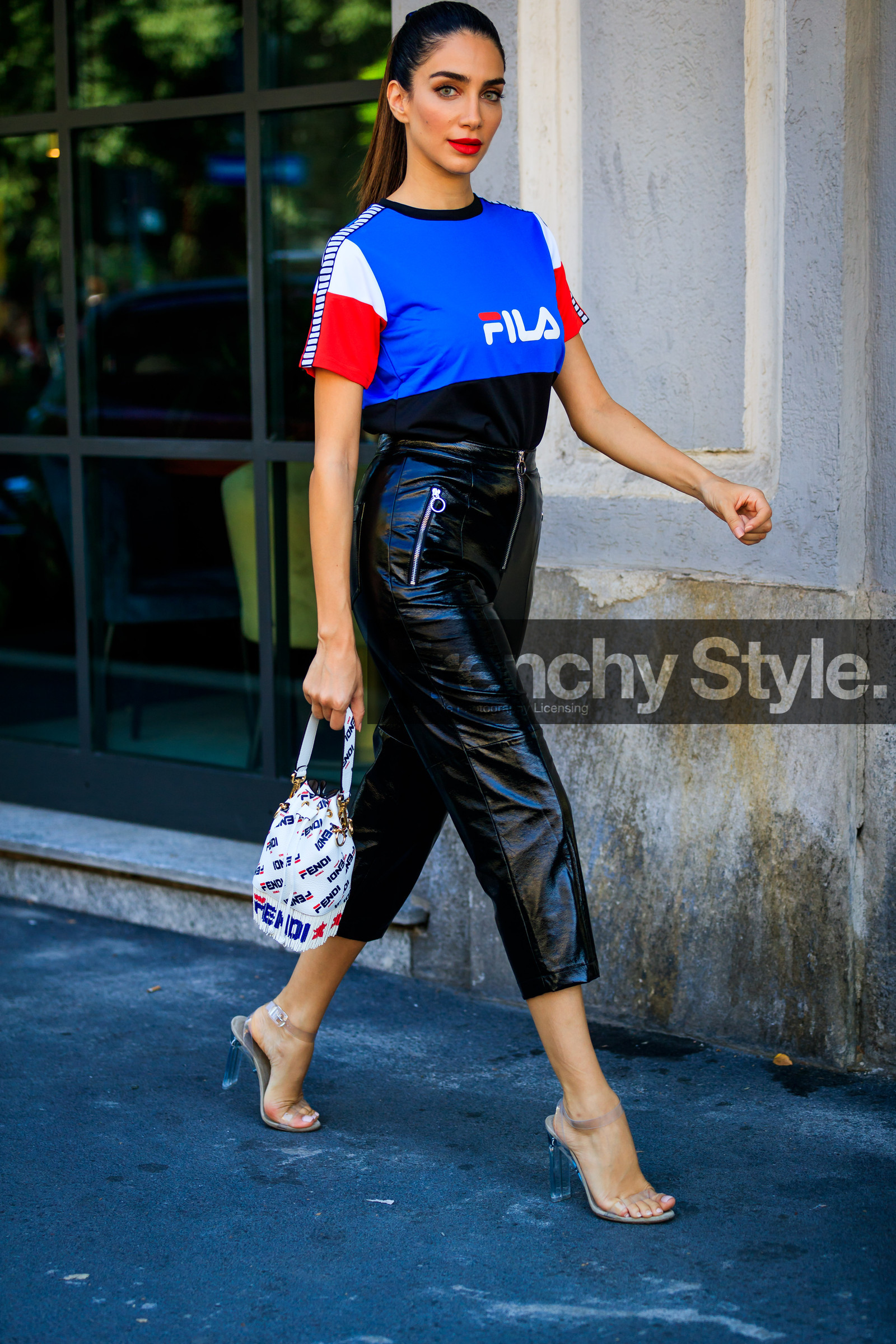 black pants, blue t shirt, crop top, fendi, fila, fringes, graphic bag, graphic top, high heels, jessica kahawaty, leather bag, leather pants, leather shoes, monogram, printed bag, printed t shirt, red lips, transparent shoes, trousers, white bag, street style, jonathan paciullo, FW, frenchystyle, fashion week, MFW, MILAN, SPRING SUMMER 2019, SS 19, vertical, full length