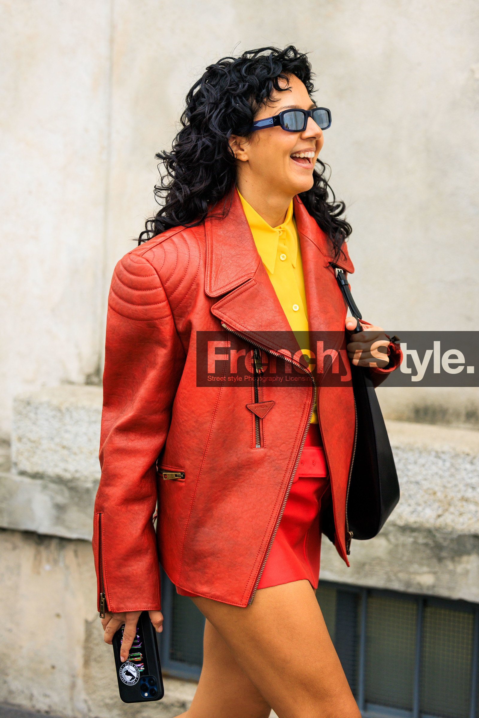 leather jacket, red jacket, prada jacket, red look, yellow shirt, mini skirt, red mini skirt, curls, black sunglasses, iphone, black handbag, street style, jonathan paciullo, FW, frenchystyle, fashion week, MFW, MILAN, FALL WINTER 2022_2023, AUTUMN WINTER 2022-2023, FW 22-23, vertical, atmosphere details