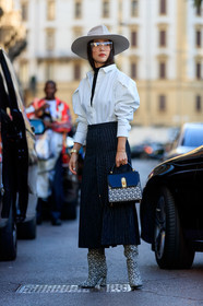 light beige hat, white shirt, balloon sleeves, black top, turtleneck top, long skirt, pleated skirt, navy blue skirt, striped skirt, monogrammed bag, monogrammed boots, high boots, high heels boots, ferragamo bag, ferragamo shoes, ferragamo boots, black leather bag, beige bag, beige boots, fashion week, frenchystyle, FW, jonathan paciullo, street style, vertical, full length, MFW, MILAN, SPRING SUMMER 2020, SS 20