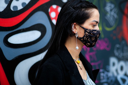 close up detail, jewel close up, earring detail, earring cuff, strassed earrings, dangling earrings, pearl earrings, silvered earrings, mask detail, beige leather jacket, sleeveless jacket, nude top, monogrammed top, marine serre top, black leather bag, crossbody phone, jacquemus bag, black sunglasses, covid face mask, louis vuitton, monogramme, fashion week, frenchystyle, FW, jonathan paciullo, street style, PFW, PARIS, SPRING SUMMER 2021, SS 21, horizontal, atmosphere details, detail