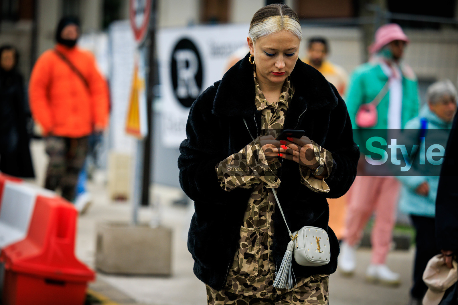 white hair, golden loops, black coat, furry coat, military print shirt, kaki shirt, orange nails, iphone, watch, mini bag, crossbody bag, saint laurent bag, fashion week, frenchystyle, FW, jonathan paciullo, street style, PFW, PARIS, menswear, FALL WINTER 2022-2023, AUTUMN WINTER 2022-2023, FW 22-23, atmosphere details, detail, horizontal