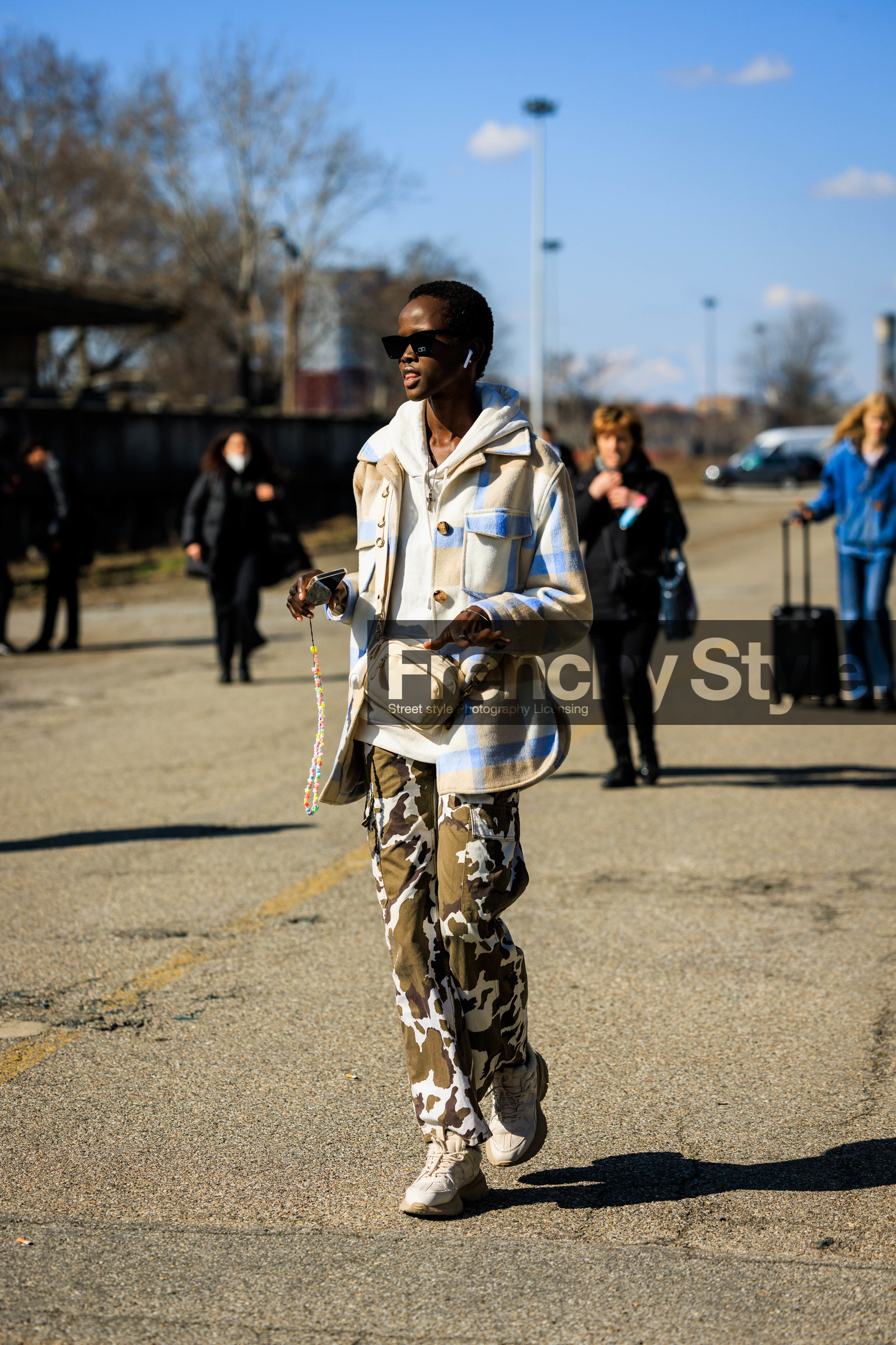 beige crossbody bag, plaid shirt, beige shirt, blue plaid shirt, black sunglasses, cow print pants, kaki pants, dual toned pants, white sneakers, white hoodie, animal print trousers, model, fashion week, frenchystyle, FW, jonathan paciullo, street style, vertical, full length