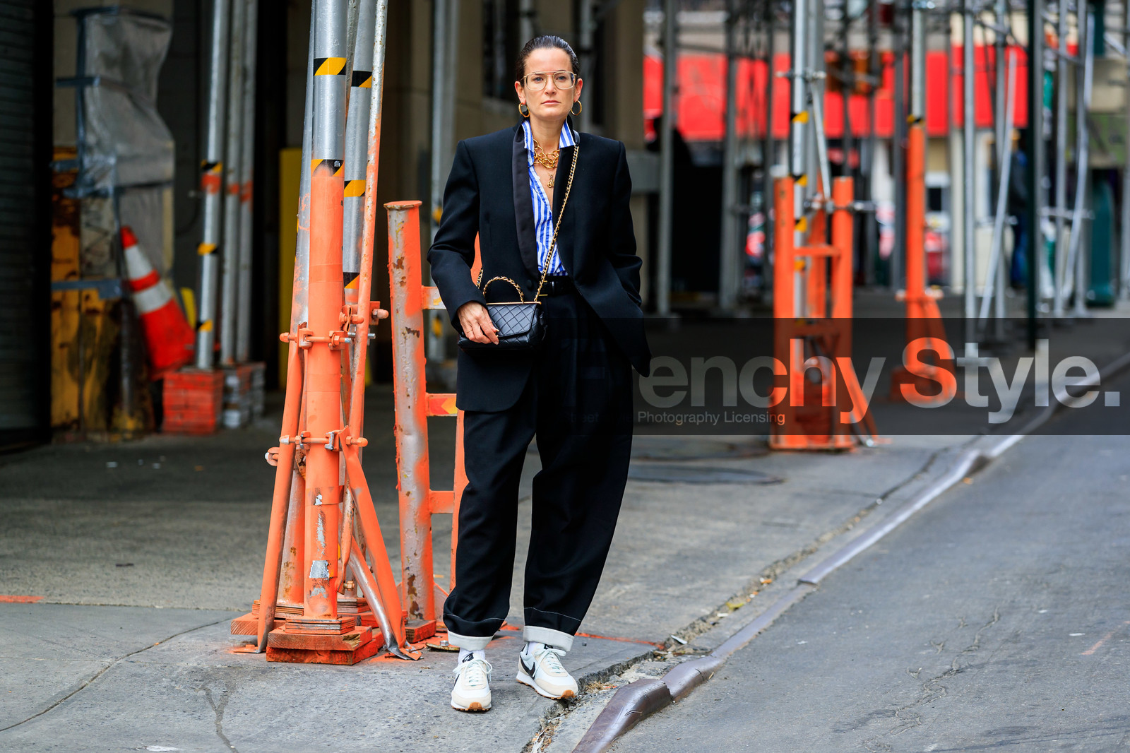 Lucy Chadwick, black jacket, black leather bag, black pants, blue shirt, white shirt, striped shirt, big chain necklace, multi necklace, charms necklace, golden frame glasses, metalic frame sunglasses, aviator glasses, hoop earrings, golden earrings, golden chain strap bag, crossbody bag, chanel bag, quilted bag, satin jacket, loose pants, nike shoes, white sneakers, golden necklace, beige sneakers, suede sneakers, fashion week, frenchystyle, FW, jonathan paciullo, street style, NYFW, NEW YORK, AUTUMN WINTER 2020-2021, FALL WINTER 2020-2021, FW 20-21, horizontal, atmosphere details, full length