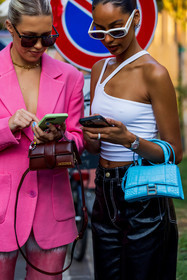 asymetrical top, bag, balenciaga bag, black pants, blue bag, bun, Caroline Ebo, chiquito bag, color, croc bag, detail, duo, hourglass bag, jacquemus bag, Jamilla Stand, leather bag, pink blazer, red bag, small bag, smartphone, sunglasses, vinyl pants, watch, white sunglasses, white top, fashion week, frenchystyle, FW, jonathan paciullo, street style, MFW, MILAN, SPRING SUMMER 2022, SS 22, vertical, atmosphere details