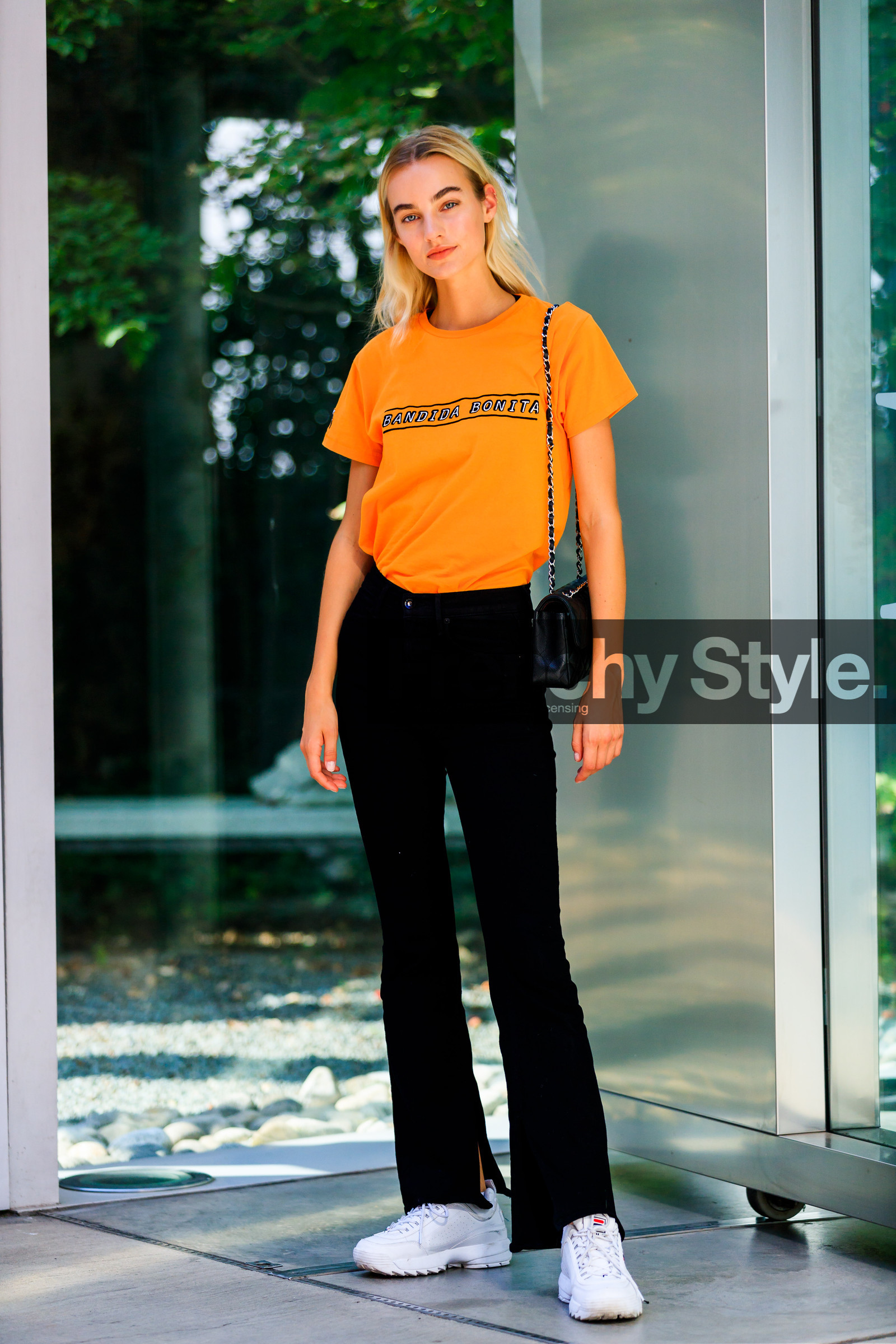 black bag, black denim, denim pants, fila, jeans, leather bag, leather shoes, Maartje Verhoef, model, orange top, printed t shirt, trousers, white sneakers, street style, jonathan paciullo, FW, frenchystyle, fashion week, MFW, MILAN, SPRING SUMMER 2019, SS 19, vertical, full length