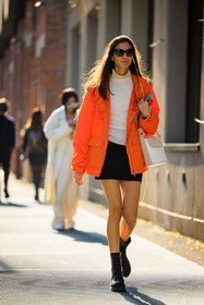 black sunglasses, orange jacket, nylon jacket, white top, rain jacker, white handbag, dual toned handbag, leather bag, black mini skirt, black bottines, leather bottines, street style, jonathan paciullo, FW, frenchystyle, fashion week, MFW, MILAN, FALL WINTER 2022_2023, AUTUMN WINTER 2022-2023, FW 22-23, vertical, full length