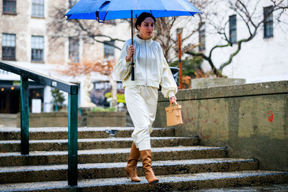 beige bag, brown boots, high boots, high heels, leather bag, leather shoes, umbrella, white jacket, white skirt, street style, jonathan paciullo, FW, frenchystyle, fashion week, NYFW, NEW YORK, AUTUMN WINTER 2018-2019, AW 18-19, FALL WINTER 2018-2019, FW 18-19, atmosphere details, horizontal, full length, erin adamson