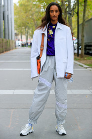 model, white jacket, light grey pants, zipped jacket, purple blouse, floral printed blouse, high collar blouse, silk blouse, sportswear, jogging pants, orange leather bag, animal skin bag, white sneakers, nike shoes, make up, make up details, studs make up, strassed make up, fashion week, frenchystyle, FW, jonathan paciullo, street style, SPRING SUMMER 2020, SS 20, PFW, PARIS, vertical, full length