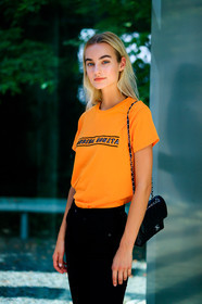 black bag, black denim, denim pants, jeans, leather bag, Maartje Verhoef, model, orange top, printed t shirt, trousers, street style, jonathan paciullo, FW, frenchystyle, fashion week, MFW, MILAN, SPRING SUMMER 2019, SS 19, vertical, atmosphere details, detail