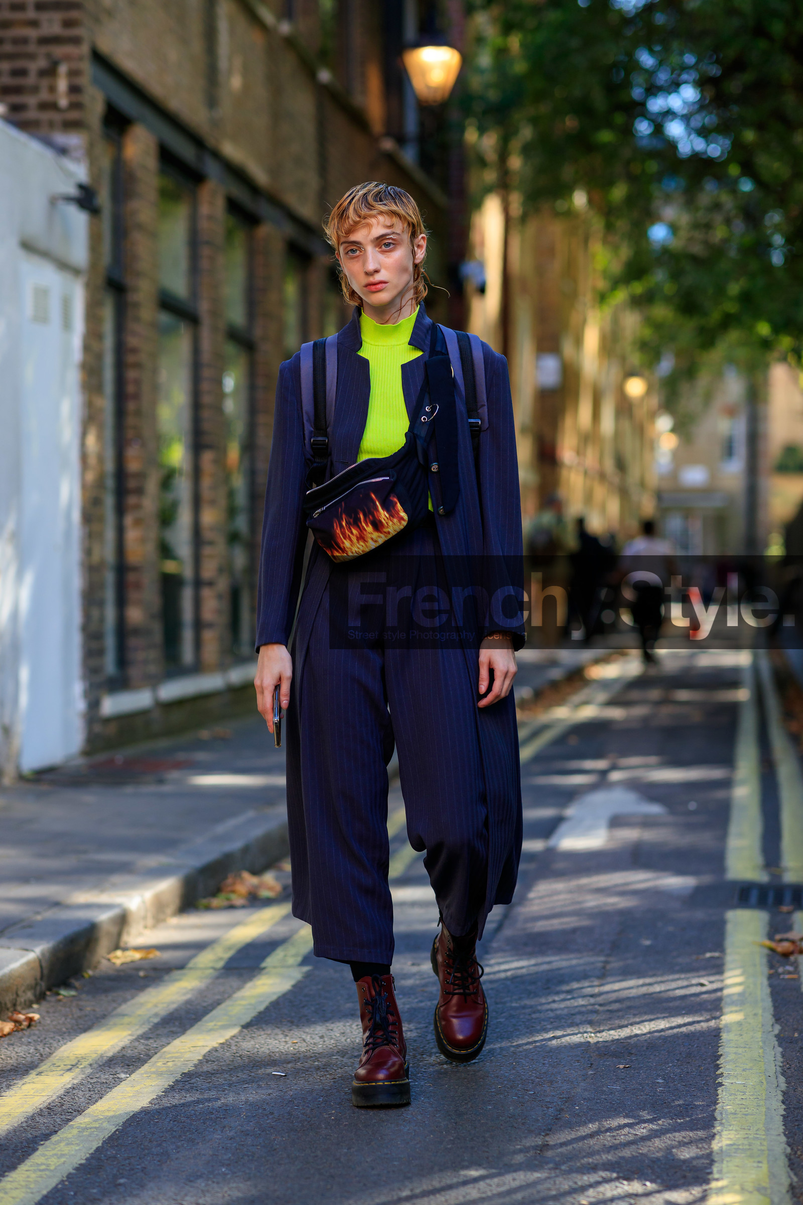 model, white eyeliner, neon top, navy blue jacket, striped jacket, long jacket, navy blue pants, cropped pants, striped pants, doc marteens shoes, laced shoes, waist bag, oversize pants, burgundy shoes, navy suits, fire printed bag, fashion week, frenchystyle, FW, jonathan paciullo, street style, vertical, full length