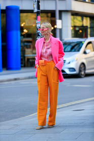 leonie hanne, color block look, neon pink jacket, oversize jacket, future shape sunglasses, neon pink shirt, pink sunglasses, miu miu shirt, sheer shirt, orange pants, oversize pants, jacquemus bag, mini bag, belt bag, orange leather bag, animal skin bag, strassed earrings, big earrings, bottega veneta shoes, squared toed shoes, chain detail shoes, fashion week, frenchystyle, FW, jonathan paciullo, street style, vertical, full length