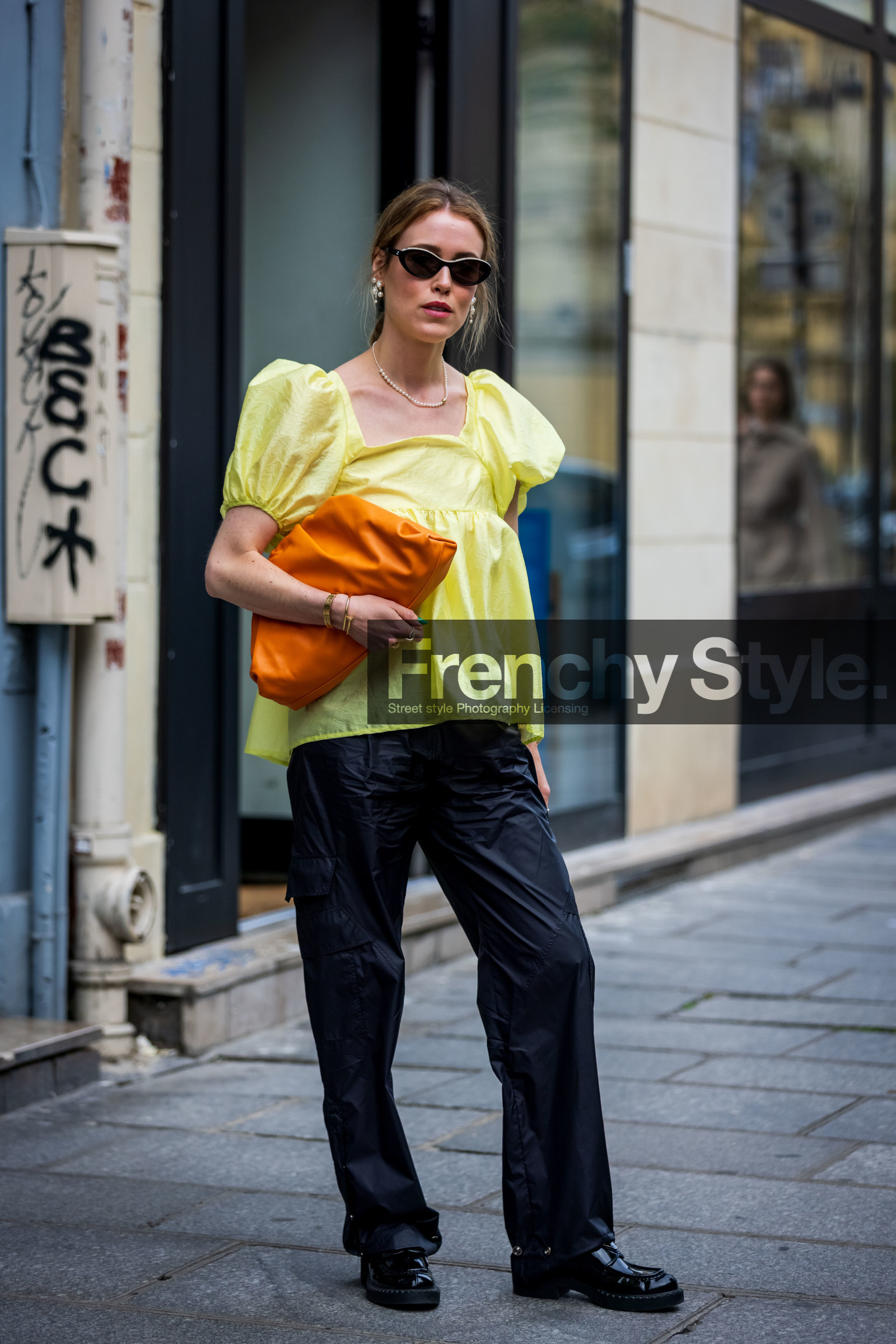 Annabel Rosendahl, bag, ballon sleeves, black loafers, black mocassins, black pants, black sunglasses, bottega veneta bag, color, leather bag, loafers, mocassins, orange bag, pants, pearl earrings, sunglasses, top, yellow top, street style, jonathan paciullo, FW, frenchystyle, fashion week, PFW, PARIS, SPRING SUMMER 2022, SS 22, vertical, full length