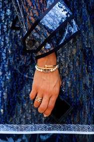 logo all over, dior bracelet, cartier bracelet, cartier clou bracelet, cartier ring, golden bracelet, golden ring, pearl bracelet, initials bracelet, close up detail, jewel close up, sheer trench coat, monogrammed trench coat, monogrammed parka, monogrammed coat, tamara kalinic, fashion week, frenchystyle, FW, jonathan paciullo, street style, PFW, PARIS, AUTUMN WINTER 2021-2022, FALL WINTER 2021-2022, FW 21-22, vertical, atmosphere details, detail
