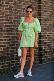light green dress, pleated dress, balloon sleeves, mini dress, rayban sunglasses, golden frame sunglasses, pearl necklace, multi earrings, multi bracelet, multi necklace, golden necklace, golden rings, golden bracelet, white leather bag, hand bag, nike shoes, hoop earrings, white sneakers, silvered sneakers, fashion week, frenchystyle, FW, jonathan paciullo, street style, vertical, full length