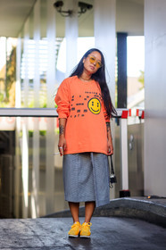 camera, christina paik, fashion week, frenchystyle, full length, FW, graphic skirt, grey skirt, jonathan paciullo, leather shoes, MENSWEAR, nike, orange sweater, PARIS, PFW, plaid, printed skirt, printed sweater, smiley, SPRING SUMMER 2018, SS 18, street style, sunglasses, tattoos, vertical, yellow sneakers