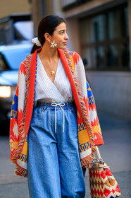 bettina looney, blue denim, denim pants, earrings, fendi, geometric, graphic bag, graphic jacket, jeans, leather bag, multicolor bag, multicolor jacket, poncho, printed bag, printed jacket, trousers, white top, MILAN, MFW, fashion week, frenchystyle, FW, jonathan paciullo, street style, AUTUMN WINTER 2019-2020, AW 19-20, FALL WINTER 2019-2020, FW 19-20, vertical, atmosphere details, detail