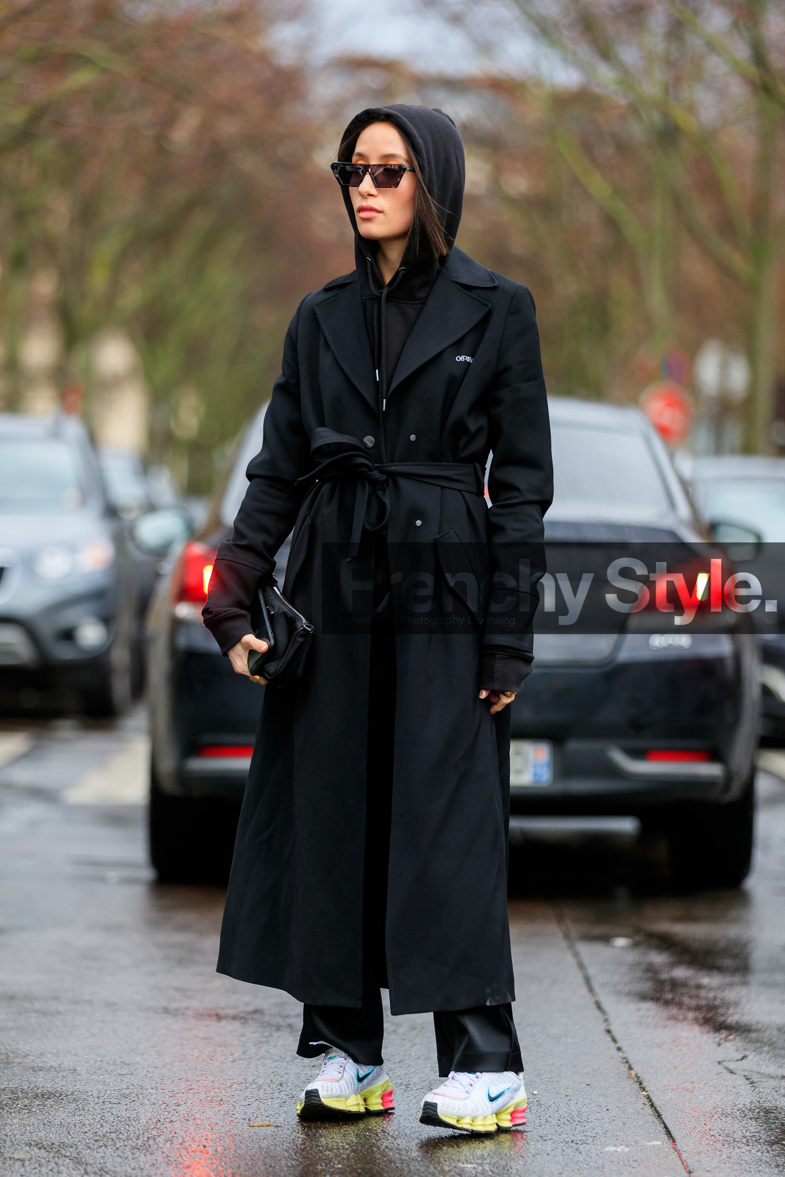 alexandra guerain, black hoodie, black trench coat, black pants, belted trench coat, off white trench coat, nike shoes, white sneakers, yellow sneakers, futurist shape sunglasses, scale sunglasses, purple sunglasses, fashion week, frenchystyle, FW, jonathan paciullo, street style, PFW, PARIS, vertical, full length