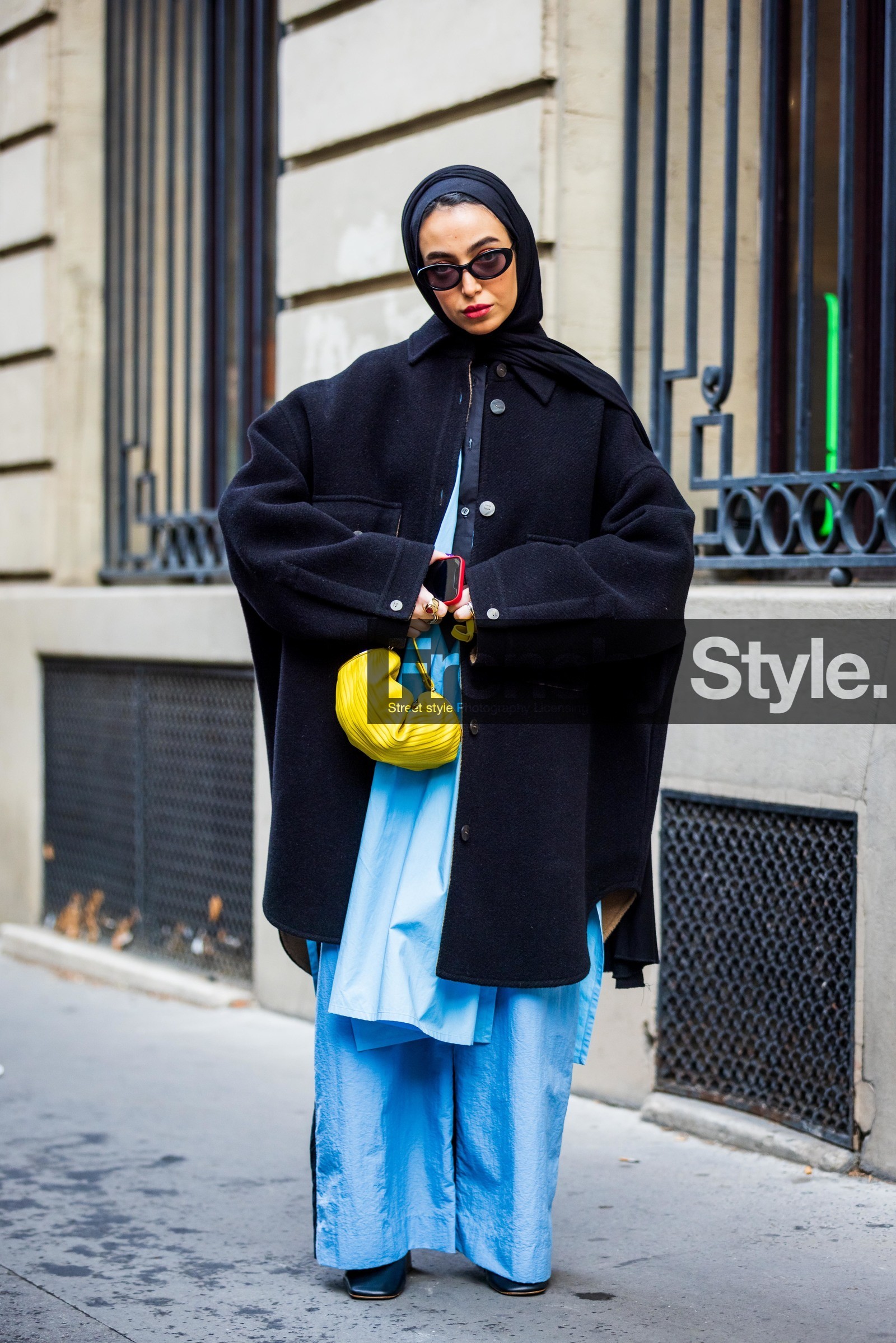 bag, black coat, black sunglasses, blue pants, coat, flare pants, hijab, large pants, Leena Al Ghouti, loewe bag, oversize coat, pants, sunglasses, yellow bag, street style, jonathan paciullo, FW, frenchystyle, fashion week, PFW, PARIS, SPRING SUMMER 2022, SS 22, vertical, full length
