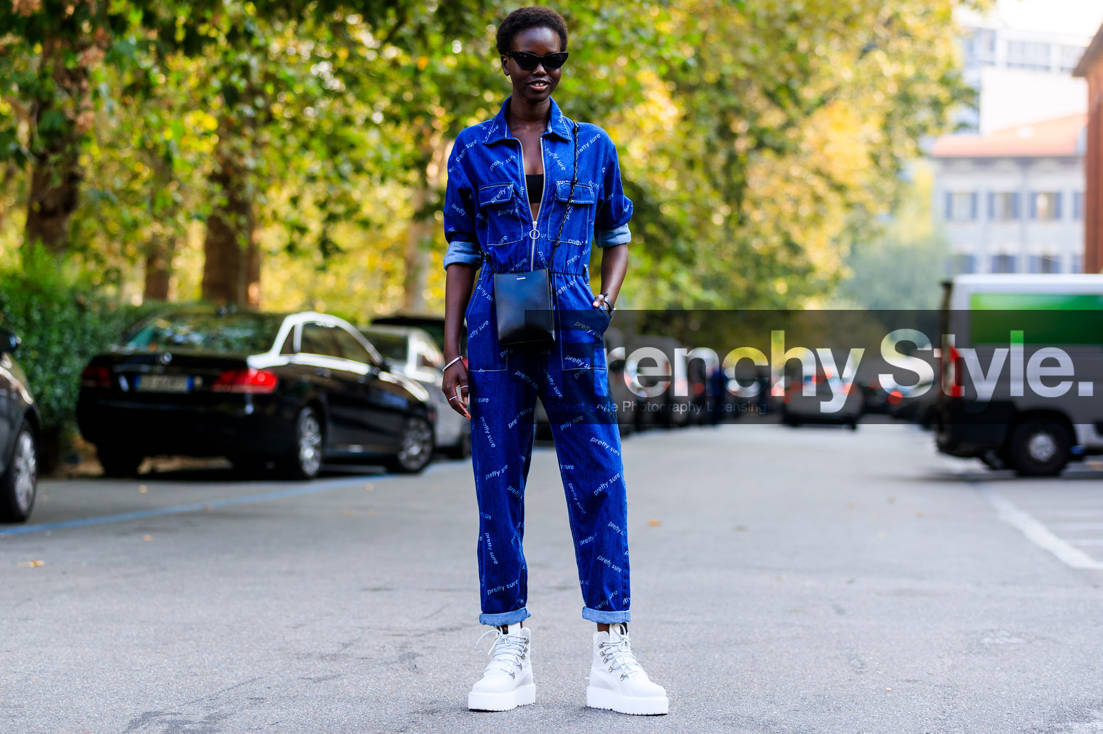 black bag, black bra, blue denim, denim jumpsuit, jil sander, leather bag, leather shoes, model, printed jumpsuit, puma, sunglasses, trousers, white sneakers, street style, jonathan paciullo, FW, frenchystyle, fashion week, MFW, MILAN, SPRING SUMMER 2019, SS 19, atmosphere details, horizontal, full length