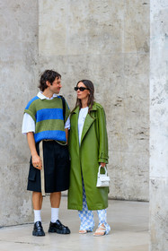 green leather coat, white t-shirt, white leather bag, mini bag, hand bag, letter printed bag, long coat, oversize coat, oversize t-shirt, checked pants, white pants, light blue pants, flare pants, silk pants, blue pants, bicolor pants, alice barbier, striped pullover, oversize pullover, green pullover, blue pullover, short sleeves pullover, sleeveless pullover, white polo shirt, black bermuda shorts, loose shorts, white socks, black leather loafers, prada shoes, prada loafers, JS roques, fashion week, frenchystyle, FW, jonathan paciullo, street style, PFW, PARIS, SPRING SUMMER 2022, SS 22, vertical, full length