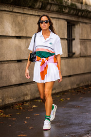 bag, black bag, black sunglasses, color, green socks, jumper, lacoste look, mini skirt, Nina Urgell Cloquell, orange jumper, pink jumper, pleated skirt, polo, skirt, sneakers, socks, stripes, sunglasses, tennis look, white polo, white skirt, white sneakers, lacoste, fashion week, frenchystyle, FW, jonathan paciullo, street style, PFW, PARIS, SPRING SUMMER 2022, SS 22, vertical, full length