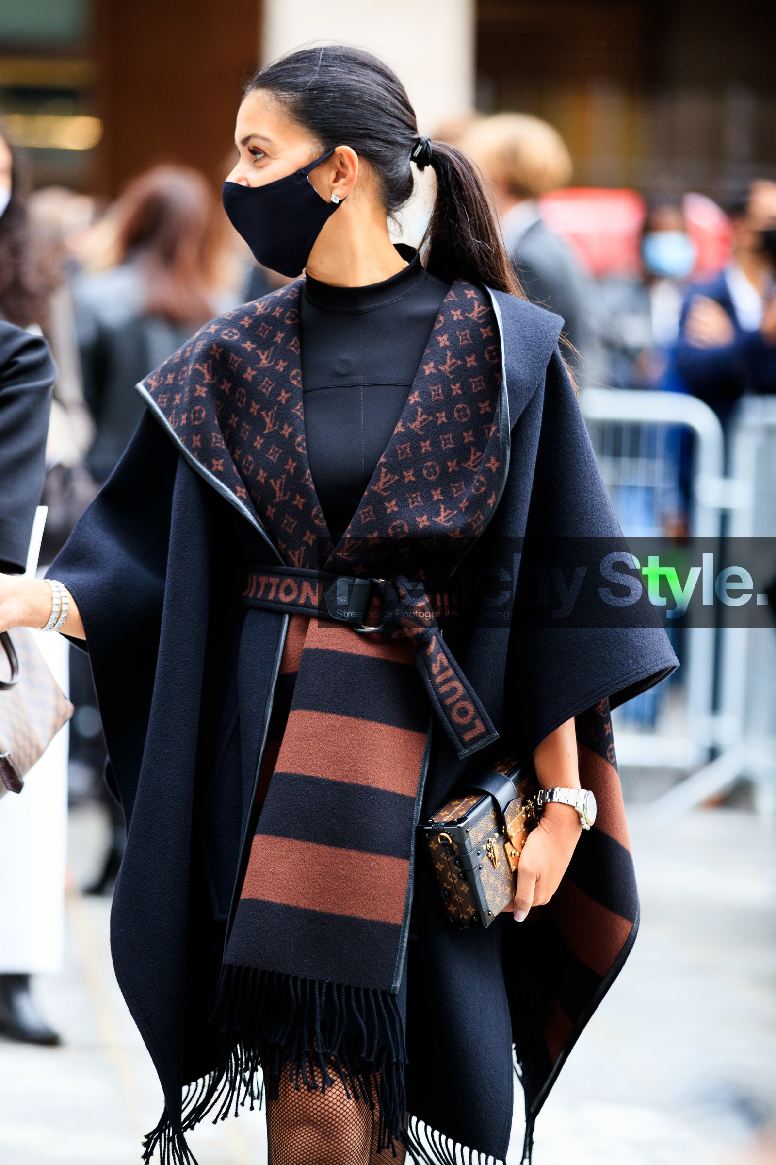 black cape, black coat, belted cape, belted coat, logo printed belt, striped cape, striped coat, fringe cape, fringe coat, monogrammed cape, monogrammed coat, monogrammed clutch, brown leather clutch, box bag, louis vuitton clutch, louis vuitton coat, louis vuitton cape, louis vuitton belt, covid face mask, PARIS, PFW, fashion week, frenchystyle, FW, jonathan paciullo, street style, SPRING SUMMER 2021, SS 21, vertical, atmosphere details, detail