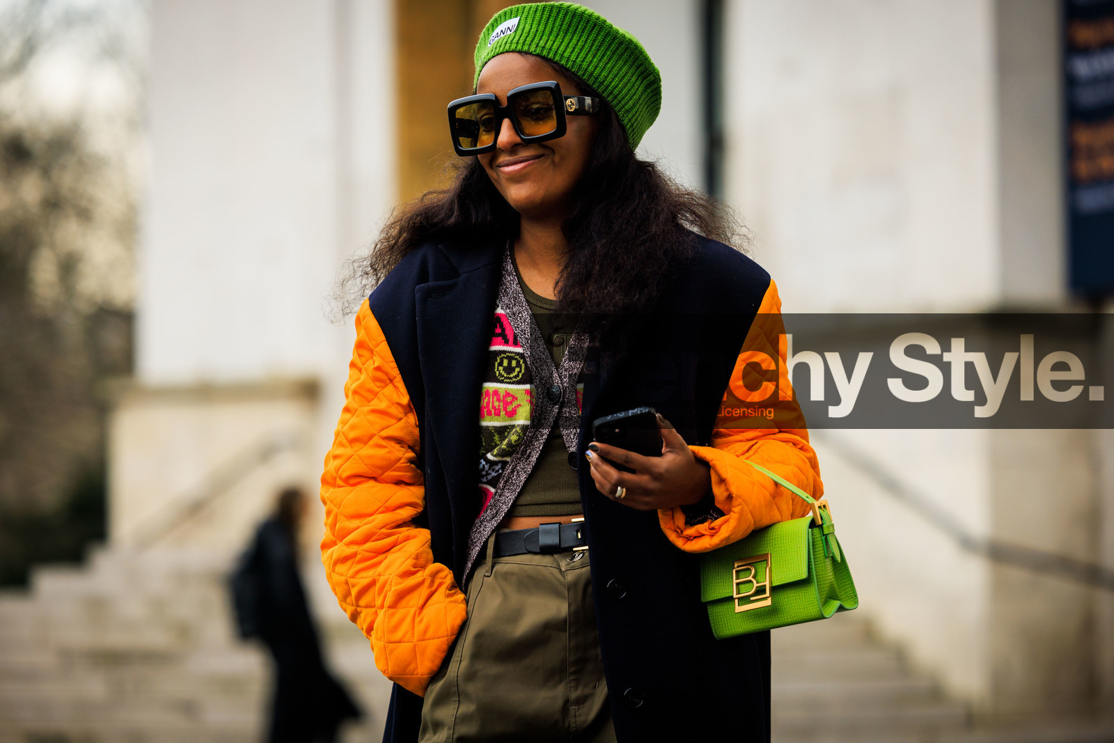 ganni beanie, green beanie, orange sleeves, black winter coat, kaki pants, baggy trousers, black belt, green handbag, black sunglasses, ganni cardigan, ganni cardigan, multicolor cardigan, green top, fashion week, frenchystyle, FW, jonathan paciullo, street style, AUTUMN WINTER 2022-2023, FALL WINTER 2022_2023, FW 22-23, PFW, PARIS, horizontal, atmosphere details, detail, dual toned jakcet