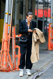 Lucy Chadwick, black jacket, black leather bag, black pants, blue shirt, white shirt, striped shirt, big chain necklace, multi necklace, charms necklace, golden frame glasses, metalic frame sunglasses, aviator glasses, hoop earrings, golden earrings, golden chain strap bag, crossbody bag, chanel bag, quilted bag, satin jacket, loose pants, beige trench coat, nike shoes, white sneakers, golden necklace, beige sneakers, suede sneakers, fashion week, frenchystyle, FW, jonathan paciullo, street style, NYFW, NEW YORK, AUTUMN WINTER 2020-2021, FALL WINTER 2020-2021, FW 20-21, vertical, full length