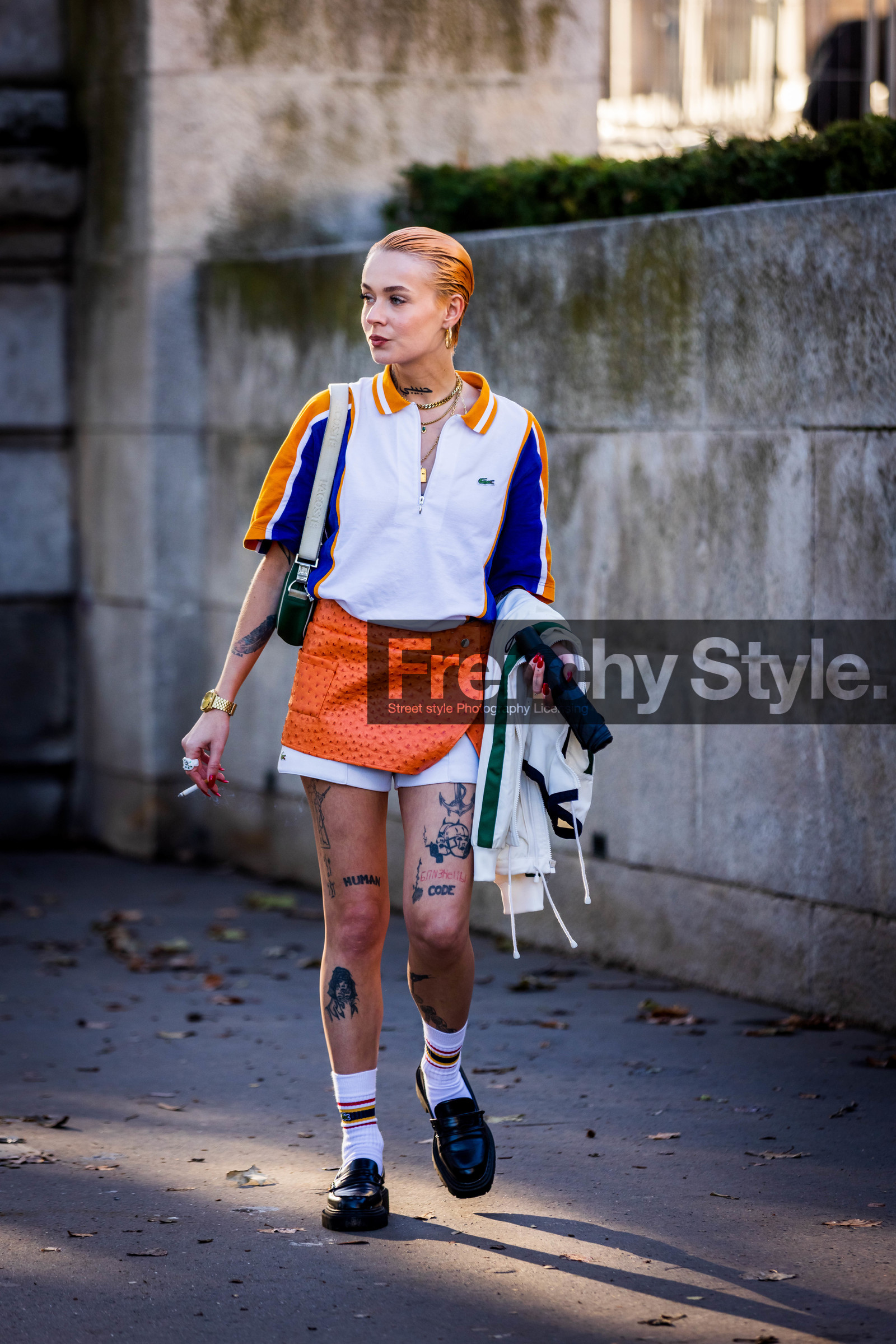 black loafers, black mocassins, blue polo, lacoste look, loafers, mini skirt, mocassins, Moesta Errabunda, orange skirt, polo, skirt, socks, tattoo, white polo, white shorts, white socks, zipped polo, lacoste, fashion week, frenchystyle, FW, jonathan paciullo, street style, PFW, PARIS, SPRING SUMMER 2022, SS 22, vertical, full length