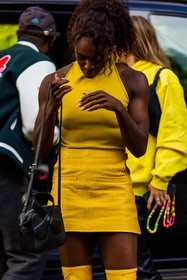 bag, black bag, color, courreges bag, courreges look, Dina Asher Smith, leather bag, leather skirt, mini skirt, skirt, top, yellow skirt, yellow top, street style, jonathan paciullo, FW, frenchystyle, fashion week, PFW, PARIS, SPRING SUMMER 2022, SS 22, vertical, atmosphere details