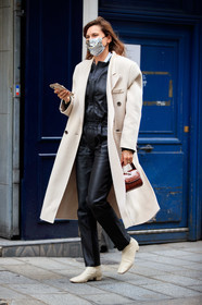 eugenie trochu, light beige coat, black leather jumpsuit, beige leather boots, brown leather bag, hand bag, kitten heels boots, flat boots, amelie pichard bag, scale bag, PARIS, PFW, fashion week, frenchystyle, FW, jonathan paciullo, street style, SPRING SUMMER 2021, SS 21, vertical, full length