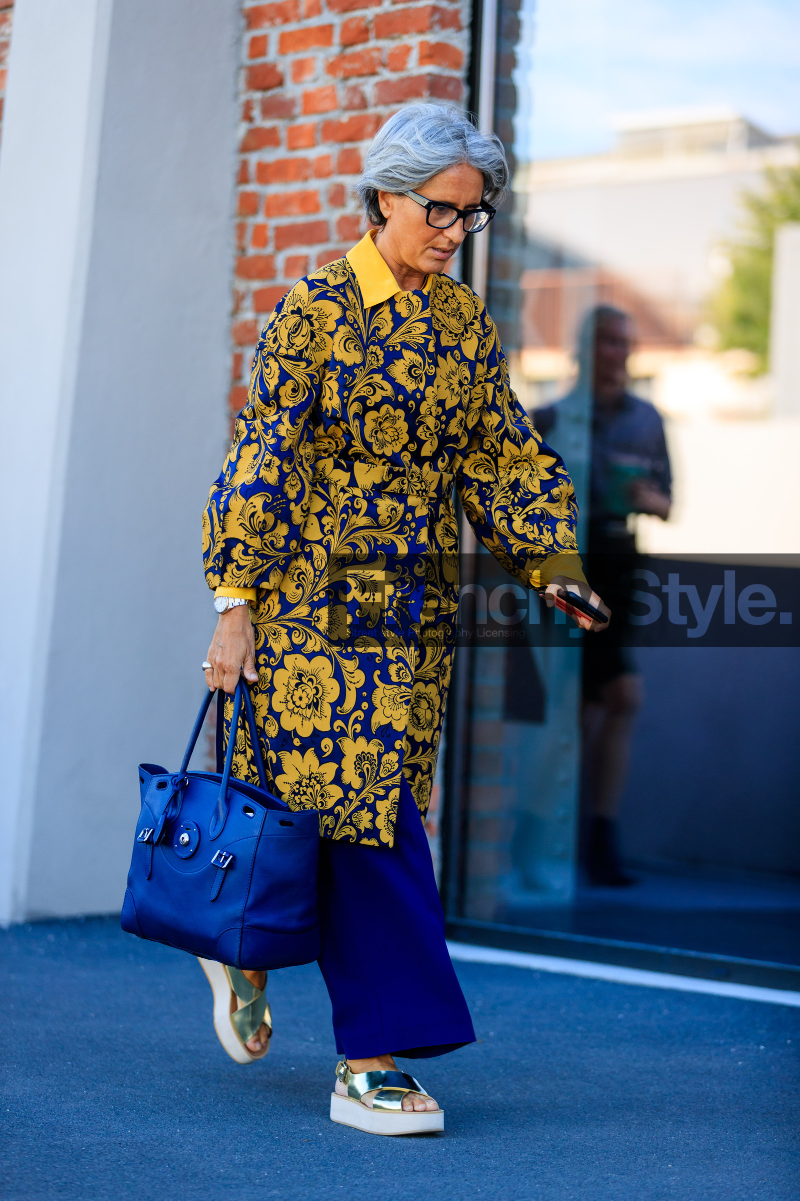 blue bag, blue pants, fashion week, floral, flowers, frenchystyle, full length, FW, golden sandals, graphic jacket, jonathan paciullo, leather bag, leather shoes, MFW, MILAN, printed jacket, SPRING SUMMER 2018, SS 18, street style, sunglasses, trousers, vertical, yellow coat