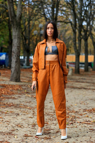 alexandra guerain, orange leather jacket, orange leather pants, orange total look, zipped jacket, black bra, cropped top, low necked top, black leather top, multi necklace, chain necklace, letters necklace, golden necklace, white leather shoes, acne studios shoes, PARIS, PFW, SPRING SUMMER 2020, SS 20, fashion week, frenchystyle, FW, jonathan paciullo, street style, vertical, full length
