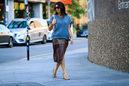 deborah reyner sebag, celine sunglasses, square glasses, black sunglasses, hoop earrings, golden earrings, oversize pull, knitwear, sleeveless pull, light blue pull, shoulder bag, mini bag, beige leather bag, piaget bracelet, golden bracelet, green pearls bracelet, brown leather skirt, mid long skirt, used pull, used skirt, bottega veneta shoes, white leather sandals, squared toed shoes, chain detail shoes, fashion week, frenchystyle, FW, jonathan paciullo, street style, atmosphere details, horizontal, full length