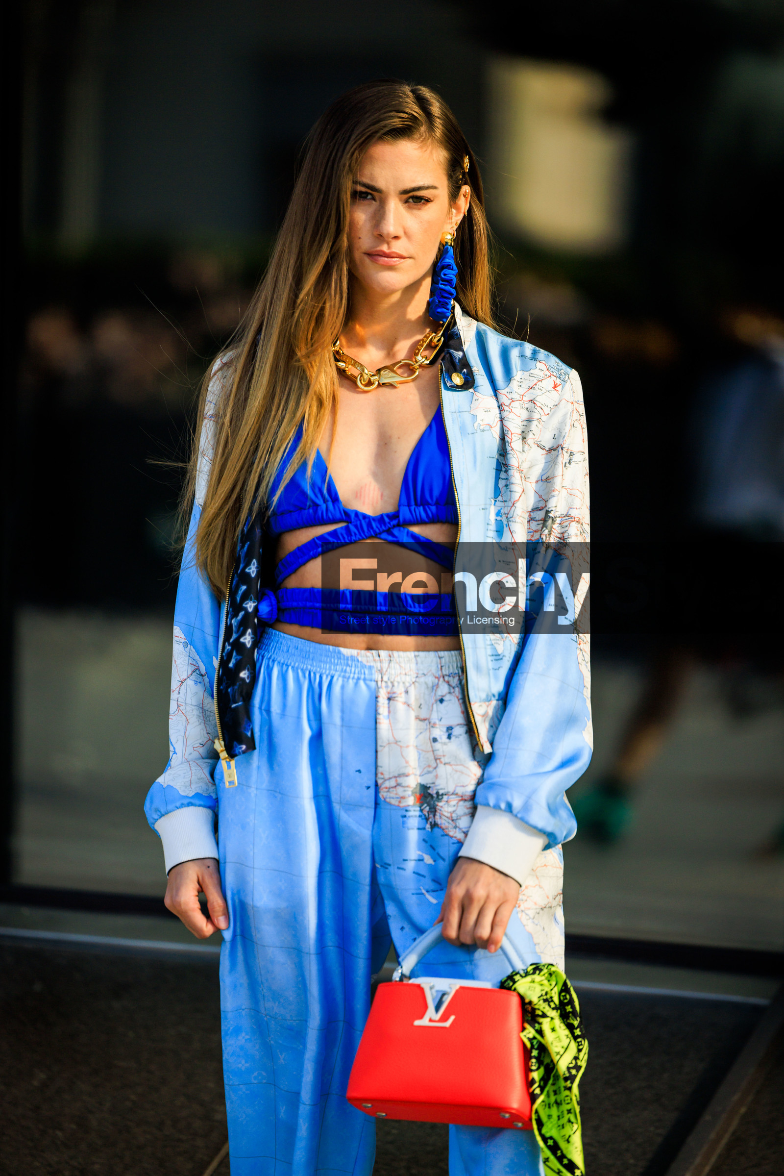 louis vuitton, printe jacket, pastel blue jacket, blue earrings, golden chain, golden necklaces, blue bra top, cut out top, printed trousers, red handbag, louis vuitton bag, logo bad, small bag, green scarf, printed scarf, pastel blue trousers, clara berry, street style, jonathan paciullo, FW, frenchystyle, fashion week, AUTUMN WINTER 2022-2023, FALL WINTER 2022_2023, FW 22-23, PFW, PARIS, vertical, detail