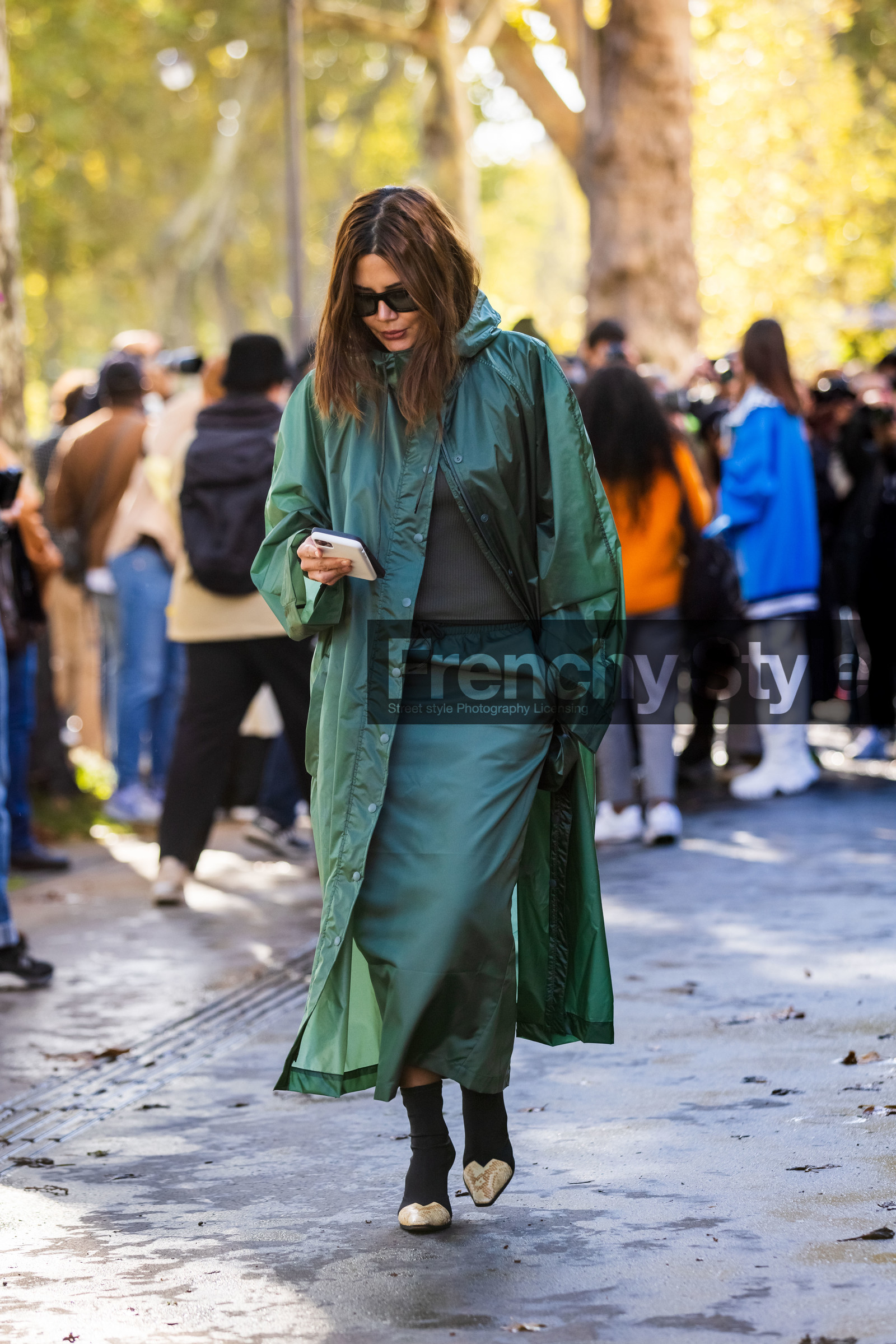 boots, Christine Centenera, green raincoat, green skirt, long skirt, raincoat, smartphone, black boots, lacoste look, lacoste, fashion week, frenchystyle, FW, jonathan paciullo, street style, PFW, PARIS, SPRING SUMMER 2022, SS 22, vertical, full length