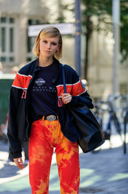 model, street wear look, 90's look, bombers jacket, college jacket, black and red jacket, black t-shirt, printed t-shirt, black leather belt, cowboy belt, tie and dye jeans, tie and dye pants, black leather bag, shoulder bag, orange pants, fashion week, frenchystyle, FW, jonathan paciullo, street style, vertical, detail, atmosphere details