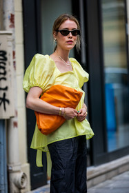 Annabel Rosendahl, bag, ballon sleeves, black pants, black sunglasses, bottega veneta bag, color, leather bag, orange bag, pants, pearl earrings, sunglasses, top, yellow top, street style, jonathan paciullo, FW, frenchystyle, fashion week, PFW, PARIS, SPRING SUMMER 2022, SS 22, vertical, atmosphere details