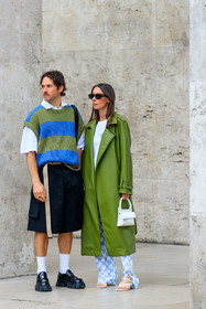 green leather coat, white t-shirt, white leather bag, mini bag, hand bag, letter printed bag, long coat, oversize coat, oversize t-shirt, checked pants, white pants, light blue pants, flare pants, silk pants, blue pants, bicolor pants, alice barbier, striped pullover, oversize pullover, green pullover, blue pullover, short sleeves pullover, sleeveless pullover, white polo shirt, black bermuda shorts, loose shorts, white socks, black leather loafers, prada shoes, prada loafers, JS roques, fashion week, frenchystyle, FW, jonathan paciullo, street style, PFW, PARIS, SPRING SUMMER 2022, SS 22, vertical, full length