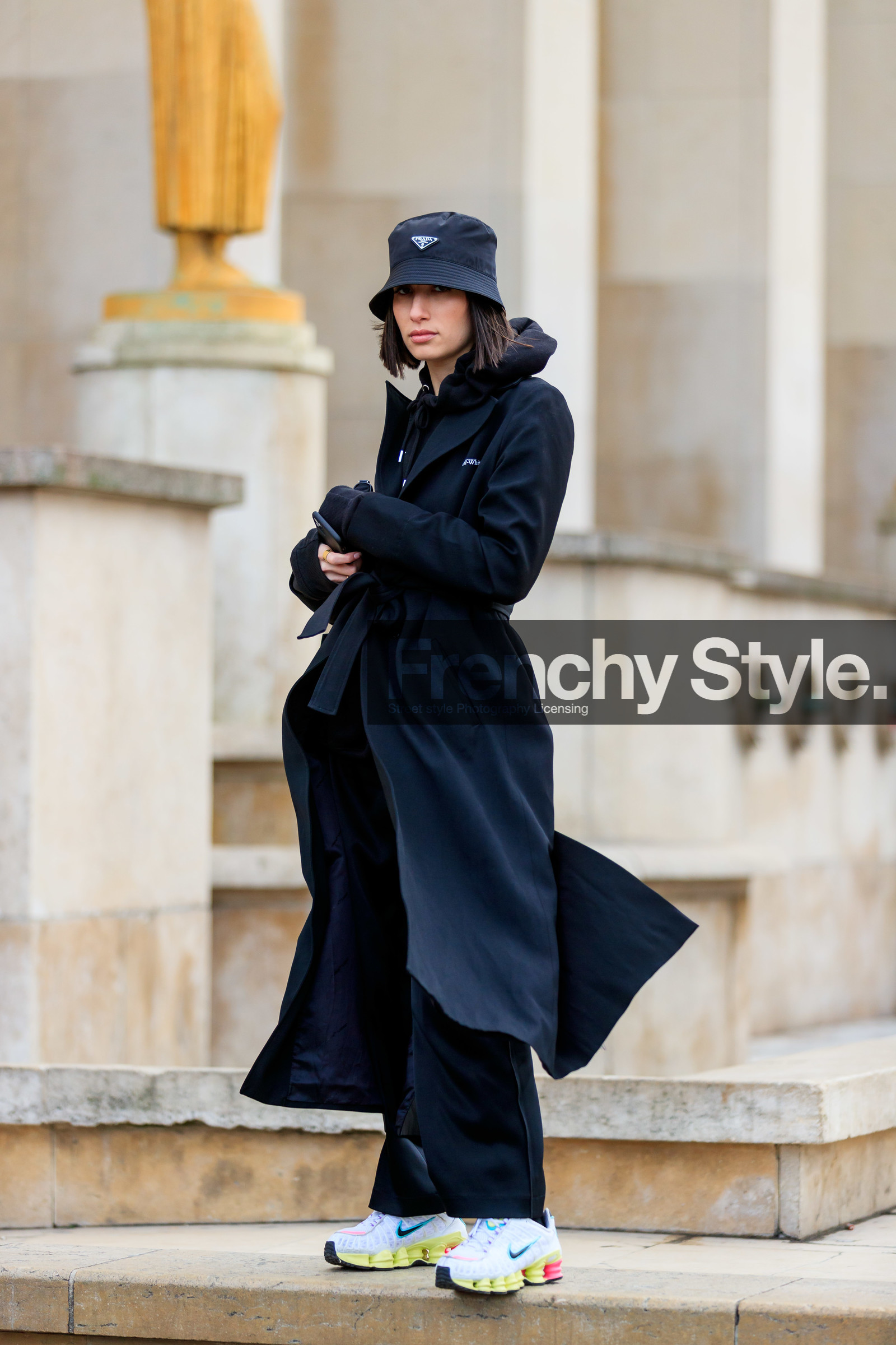 alexandra guerain, black hat, black hoodie, black trench coat, black total look, black pants, prada hat, off white trench coat, belted trench coat, white sneakers, yellow sneakers, nike shoes, fashion week, frenchystyle, FW, jonathan paciullo, street style, PFW, PARIS, AUTUMN WINTER 2020-2021, FALL WINTER 2020-2021, FW 20-21, vertical, full length
