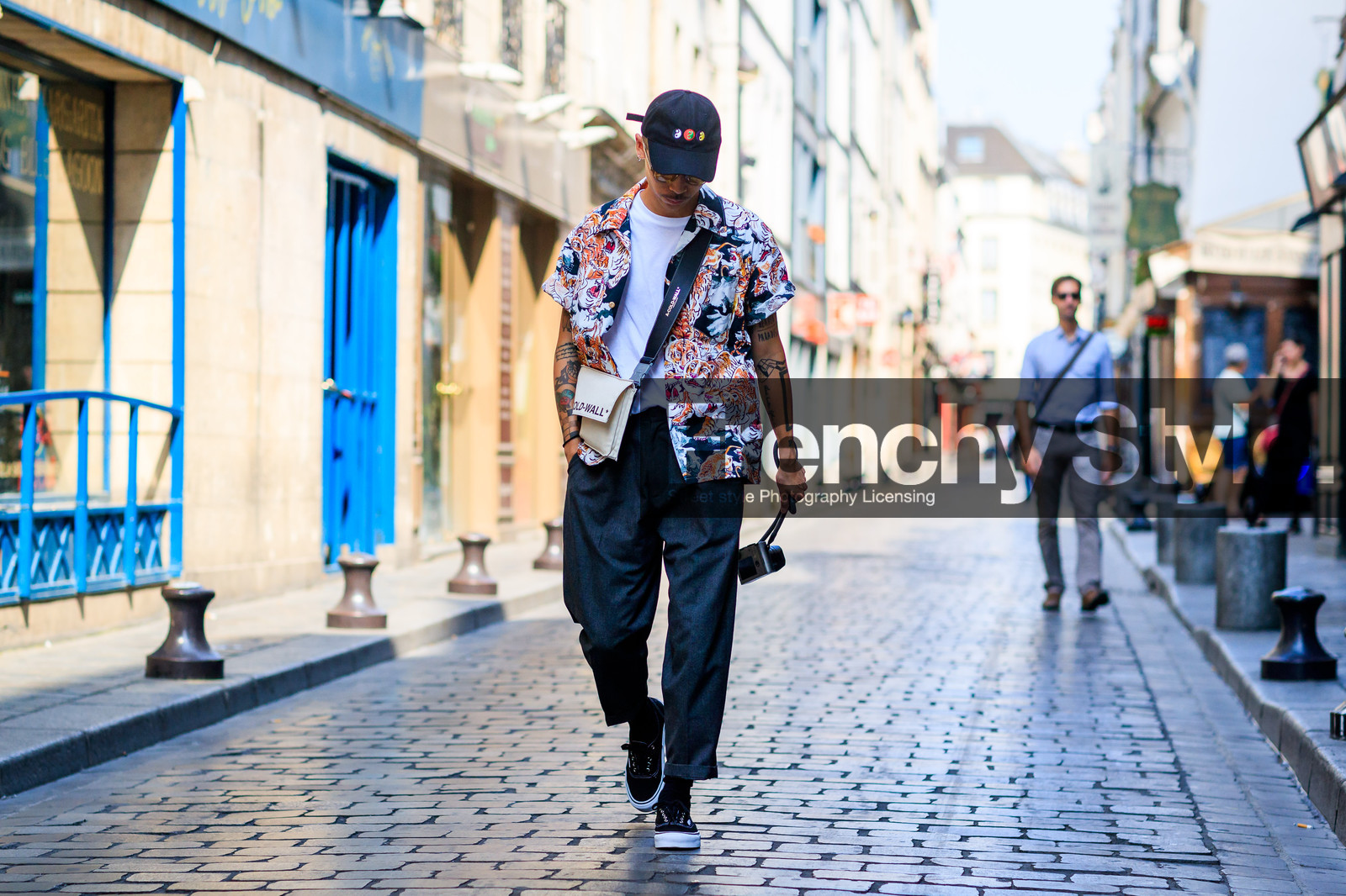 atmosphere details, black cap, black pants, black sneakers, camera, fashion week, frenchystyle, full length, FW, graphic shirt, horizontal, jonathan paciullo, leather bag, leather shoes, MENSWEAR, PARIS, PFW, printed shirt, SPRING SUMMER 2018, SS 18, street style, tattoos, trousers, white bag, white t shirt
