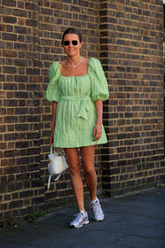 light green dress, pleated dress, balloon sleeves, mini dress, rayban sunglasses, golden frame sunglasses, pearl necklace, multi earrings, multi bracelet, multi necklace, golden necklace, golden rings, golden bracelet, white leather bag, hand bag, nike shoes, hoop earrings, white sneakers, silvered sneakers, fashion week, frenchystyle, FW, jonathan paciullo, street style, vertical, full length