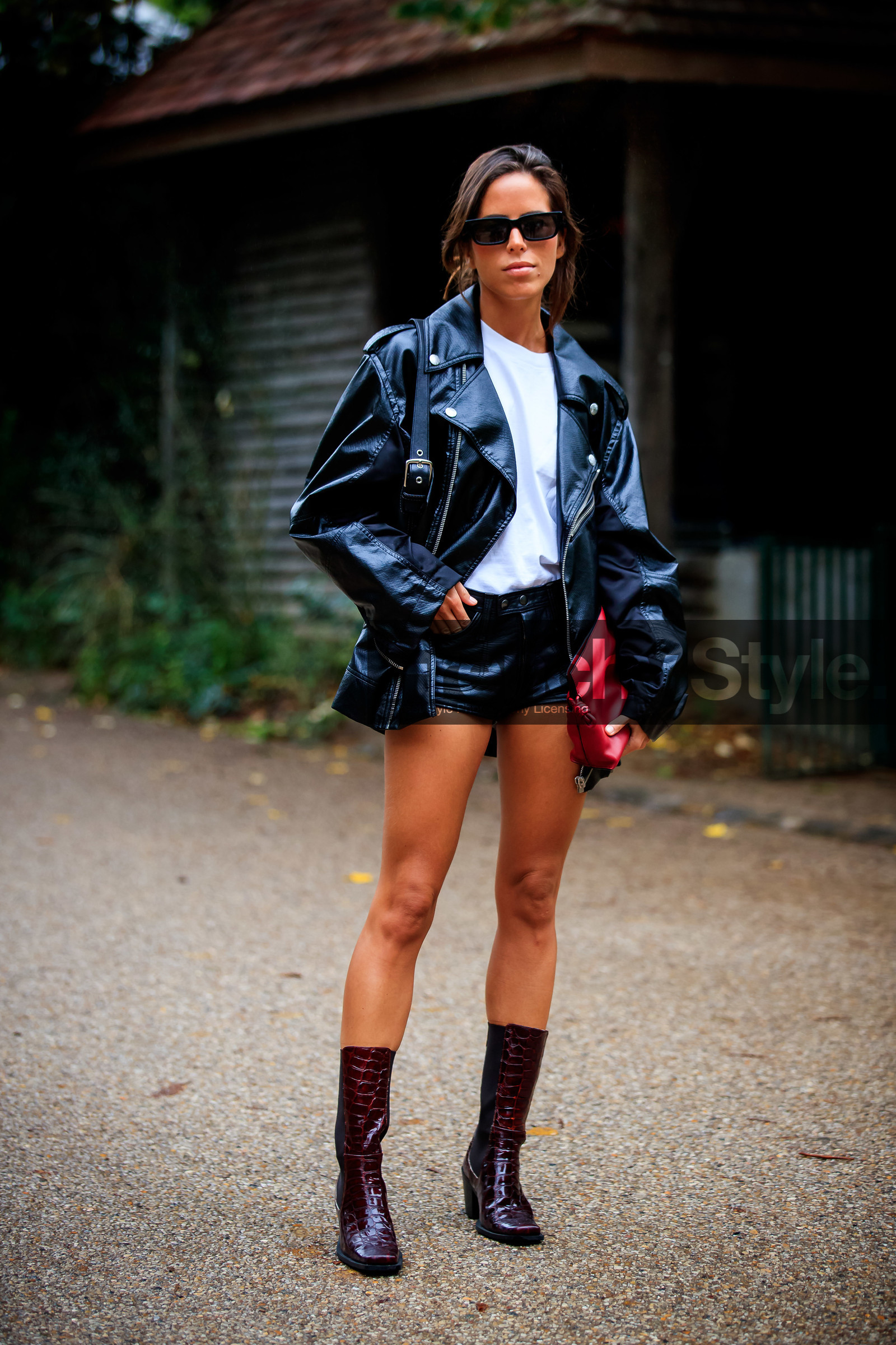 nina urgell cloquell, black leather perfecto, black leather shorts, red leather clutch, white t-shirt, oversize perfecto, mini shorts, burgundy leather boots, animal skin boots, chelsea boots, loewe clutch, black sunglasses, square shape glasses, fashion week, frenchystyle, FW, jonathan paciullo, street style, PFW, PARIS, SPRING SUMMER 2021, SS 21, vertical, full length