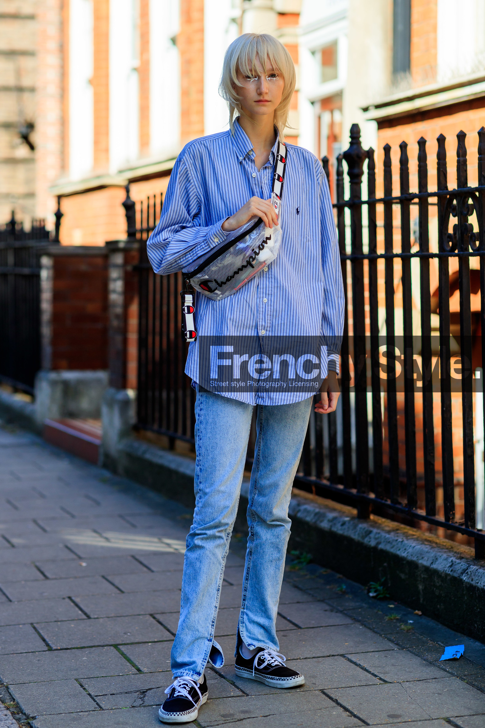 model, ralph lauren shirt, light blue shirt, striped shirt, man shirt, white eyeliner, make up, eye make up, waist bag, champion bag, denim, jeans, vans shoes, black sneackers, light blue jeans, logo shoulder strap, fashion week, frenchystyle, FW, jonathan paciullo, street style, vertical, full length